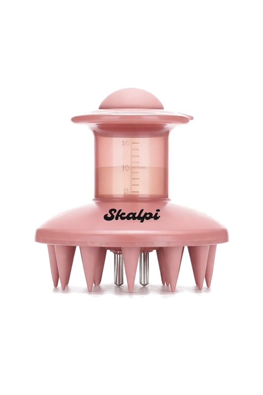 The pink Skalpi scalp applicator, showing its soft silicone bristles and clear 15ml reservoir